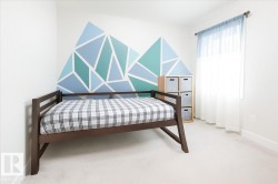 Bedroom featuring baseboards and light carpet - 