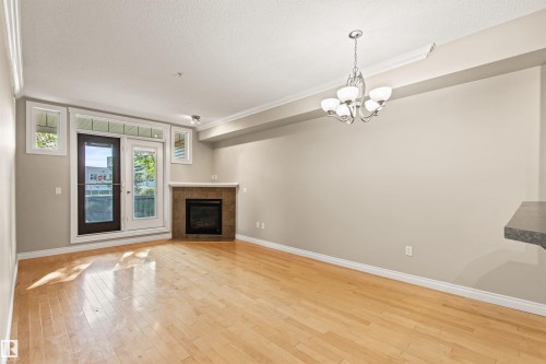 112 12408 15 Avenue, Edmonton, AB - Indoor Photo Showing Living Room With Fireplace