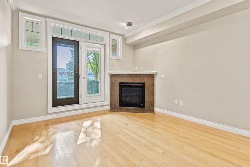 112 12408 15 Avenue, Edmonton, AB - Indoor Photo Showing Living Room With Fireplace