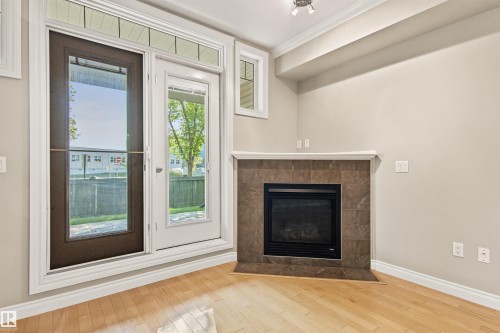 112 12408 15 Avenue, Edmonton, AB - Indoor Photo Showing Living Room With Fireplace