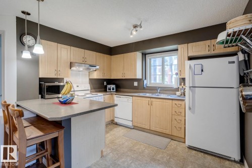 218 11449 Ellerslie Road Sw, Edmonton, AB - Indoor Photo Showing Kitchen With Double Sink