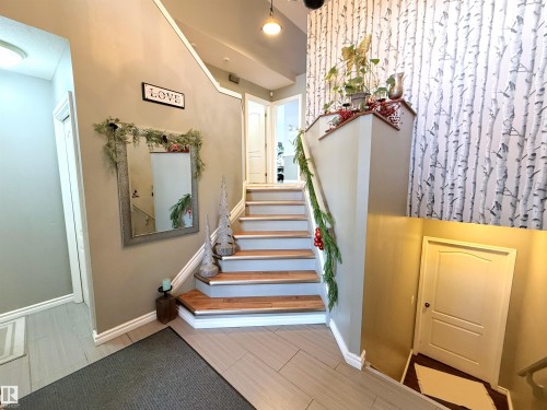 Staircase with baseboards and wood finish floors - 62 Willowby Close, Stony Plain, AB - Indoor Photo Showing Other Room