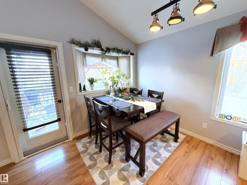 Dining area with light wood-style floors and lofted ceiling - 62 Willowby Close, Stony Plain, AB - Indoor Photo Showing Dining Room