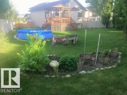 Fenced backyard with a deck and a gazebo - 