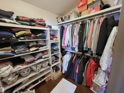 Spacious closet featuring dark wood finished floors - 