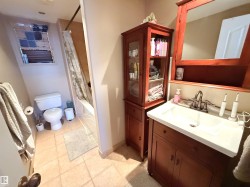 Bathroom featuring vanity, shower / bath combination with curtain, and light tile patterned floors - 