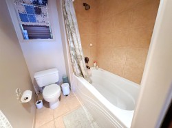 Full bath featuring tile patterned flooring and shower / bathtub combination with curtain - 
