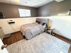 Bedroom featuring an ornate ceiling and wood finished floors - 