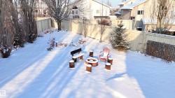 Yard layered in snow featuring a fenced backyard - 