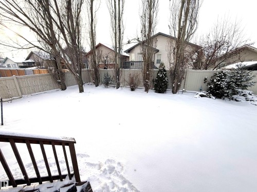 Yard covered in snow with a fenced backyard - 62 Willowby Close, Stony Plain, AB - Outdoor