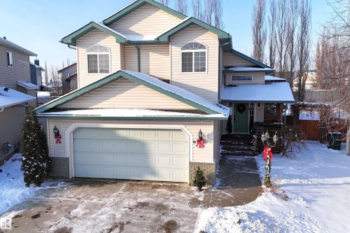 Traditional home with concrete driveway, a garage, and a porch - 62 Willowby Close, Stony Plain, AB - Outdoor