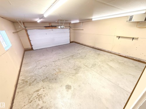 Garage featuring a heating unit and baseboards - 62 Willowby Close, Stony Plain, AB - Indoor Photo Showing Garage