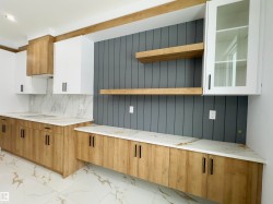 Kitchen with white cabinets, light marble finish flooring, brown cabinets, open shelves, and backsplash - 