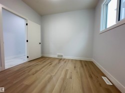 Empty room with light wood-style floors and baseboards - 