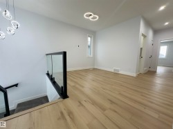 Interior space with wood finished floors, plenty of natural light, and recessed lighting - 