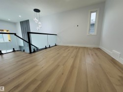 Unfurnished living room featuring light wood-style floors, plenty of natural light, and recessed lighting - 