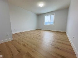 Unfurnished room with light wood finished floors and baseboards - 