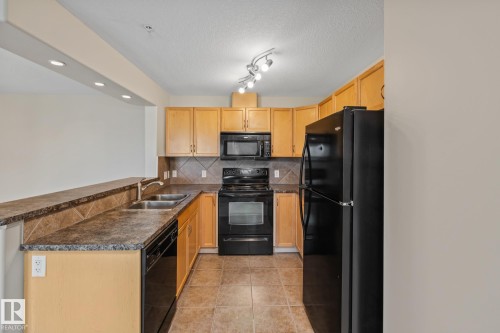 313 11615 Ellerslie Road, Edmonton, AB - Indoor Photo Showing Kitchen With Double Sink