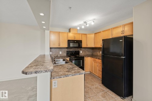 313 11615 Ellerslie Road, Edmonton, AB - Indoor Photo Showing Kitchen With Double Sink