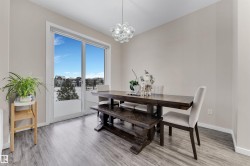 Dining space featuring a chandelier and light wood-style floors - 