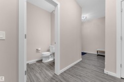 Bathroom with toilet and light wood finished floors - 
