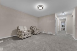Sitting room with carpet flooring and baseboards - 