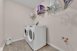 Laundry room featuring baseboards and washing machine and dryer - 