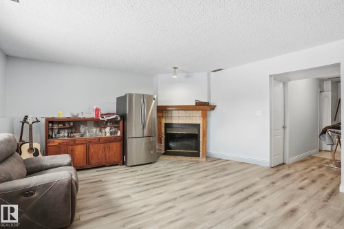 3623 24 Avenue, Edmonton, AB - Indoor Photo Showing Living Room With Fireplace