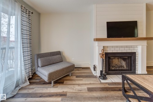 404 10420 93 Street, Edmonton, AB - Indoor Photo Showing Living Room With Fireplace
