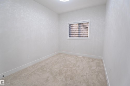 Unfurnished room with light carpet and baseboards - 244 Rolston Wynd, Leduc, AB - Indoor Photo Showing Other Room