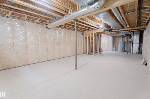 Unfinished basement with electric water heater and heating unit - 244 Rolston Wynd, Leduc, AB - Indoor Photo Showing Basement