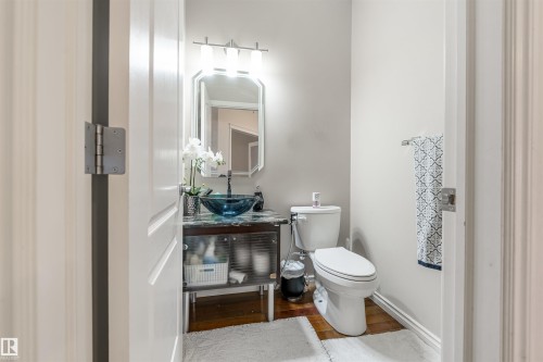 Half bath featuring wood finished floors and vanity - 20524 58 Avenue, Edmonton, AB - Indoor Photo Showing Bathroom