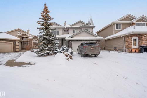View of front of home featuring a chimney and a garage - 20524 58 Avenue, Edmonton, AB - Outdoor With Facade