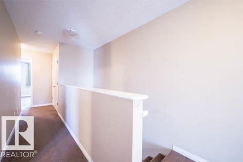 Hallway featuring an upstairs landing, carpet, and a textured ceiling - 3117 Arthurs Crescent, Edmonton, AB - Indoor Photo Showing Other Room