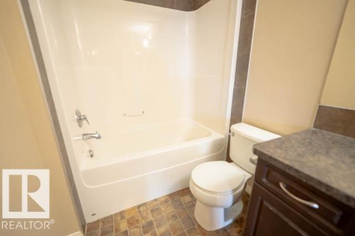 Bathroom with vanity, shower / bathtub combination, and stone finish flooring - 3117 Arthurs Crescent, Edmonton, AB - Indoor Photo Showing Bathroom