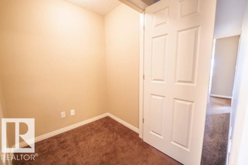 Spare room featuring dark colored carpet and a textured ceiling - 3117 Arthurs Crescent, Edmonton, AB - Indoor Photo Showing Other Room