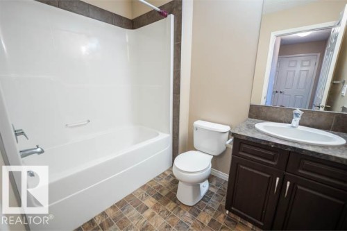 Bathroom with vanity,  shower combination, and stone finish flooring - 3117 Arthurs Crescent, Edmonton, AB - Indoor Photo Showing Bathroom