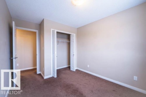 Unfurnished bedroom with dark colored carpet and a closet - 3117 Arthurs Crescent, Edmonton, AB - Indoor Photo Showing Other Room