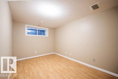 Empty room featuring a textured ceiling and light wood finished floors - 3117 Arthurs Crescent, Edmonton, AB - Indoor Photo Showing Other Room