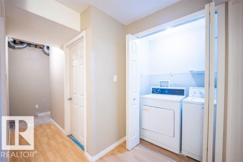 Laundry room featuring light wood finished floors and separate washer and dryer - 3117 Arthurs Crescent, Edmonton, AB - Indoor Photo Showing Laundry Room