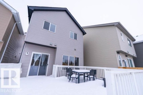 Back of house with a wooden deck and outdoor dining space - 3117 Arthurs Crescent, Edmonton, AB - Outdoor With Exterior
