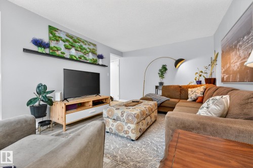 Living area featuring a textured ceiling and wood finished floors - 7 Grandview Ridge, St. Albert, AB - Indoor Photo Showing Living Room