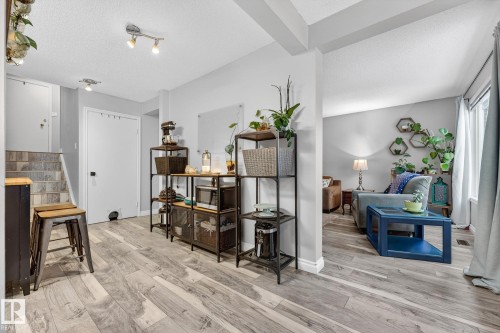 Sitting room featuring light wood finished floors, a textured ceiling, and stairway - 7 Grandview Ridge, St. Albert, AB - Indoor