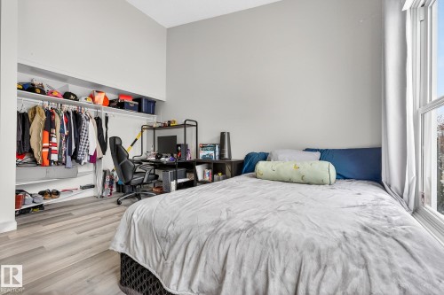 Bedroom featuring a desk, a closet, and wood finished floors - 7 Grandview Ridge, St. Albert, AB - Indoor Photo Showing Bedroom