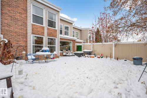 Snow covered house with brick siding, a fenced backyard, and a patio area - 7 Grandview Ridge, St. Albert, AB - Outdoor