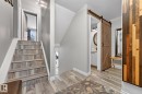 Stairs featuring a textured ceiling, wood finished floors, and a barn door - 7 Grandview Ridge, St. Albert, AB  - Indoor Photo Showing Other Room 