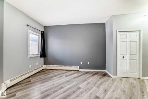 Empty room with a baseboard heating unit and light wood-style flooring - 507 11716 100 Avenue, Edmonton, AB - Indoor Photo Showing Other Room