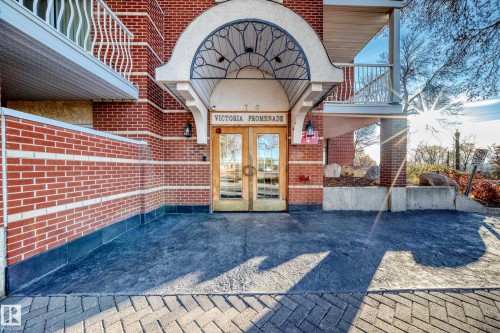 View of exterior entry with french doors, brick siding, and a patio area - 507 11716 100 Avenue, Edmonton, AB - Outdoor
