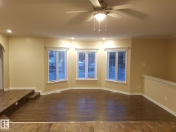 Spare room with dark wood-style flooring, recessed lighting, ornamental molding, a ceiling fan, and arched walkways - 