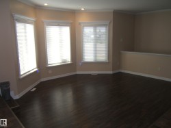 Empty room with dark wood-style floors, ornamental molding, and recessed lighting - 